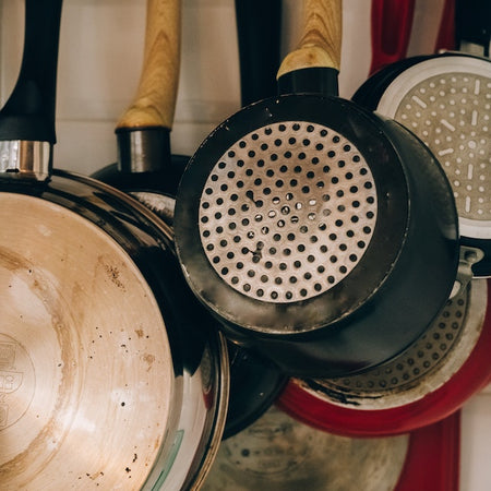 Photo by Leeloo Thefirst: https://www.pexels.com/photo/set-of-pans-hanging-on-a-wall-5447100/